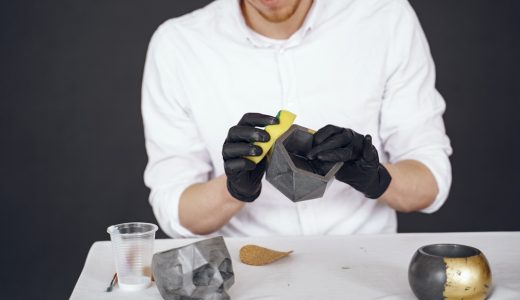 Man works with a cement. Concrete cement grey pot. Hand made concrete planters for succulents and cacti.